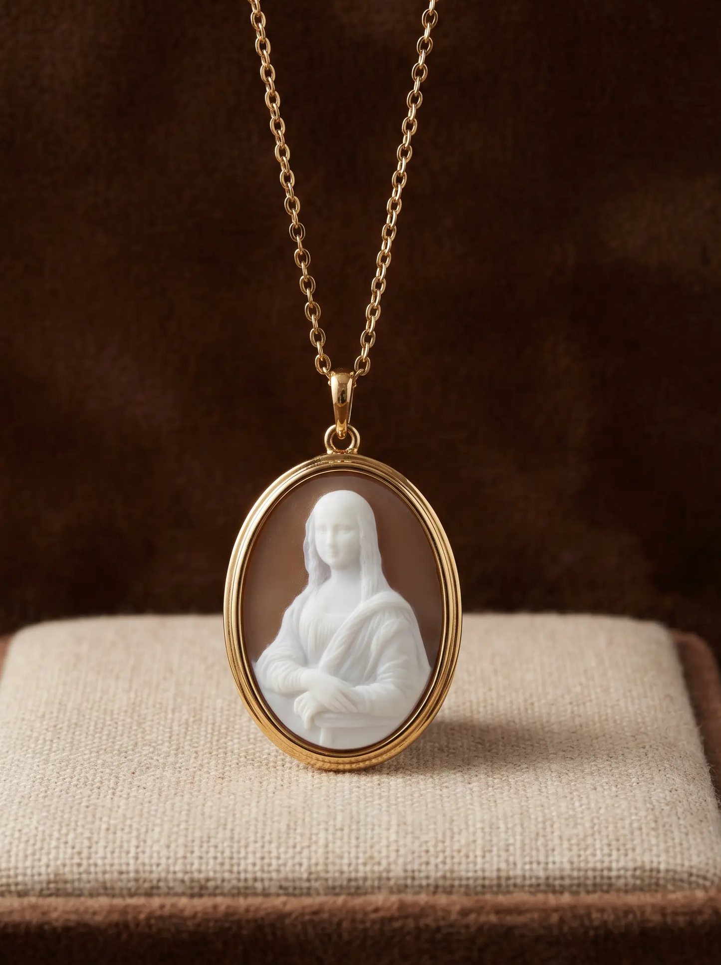Gold necklace with a pendant featuring the mona lisa white silhouette carved by hand from sardonyx sea shell