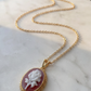 red agate rose pendant with a gold frame handmade in italy