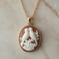 Gold necklace with a pendant featuring two birds on a branch