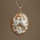 Gold necklace with a pendant featuring two white birds on a branch