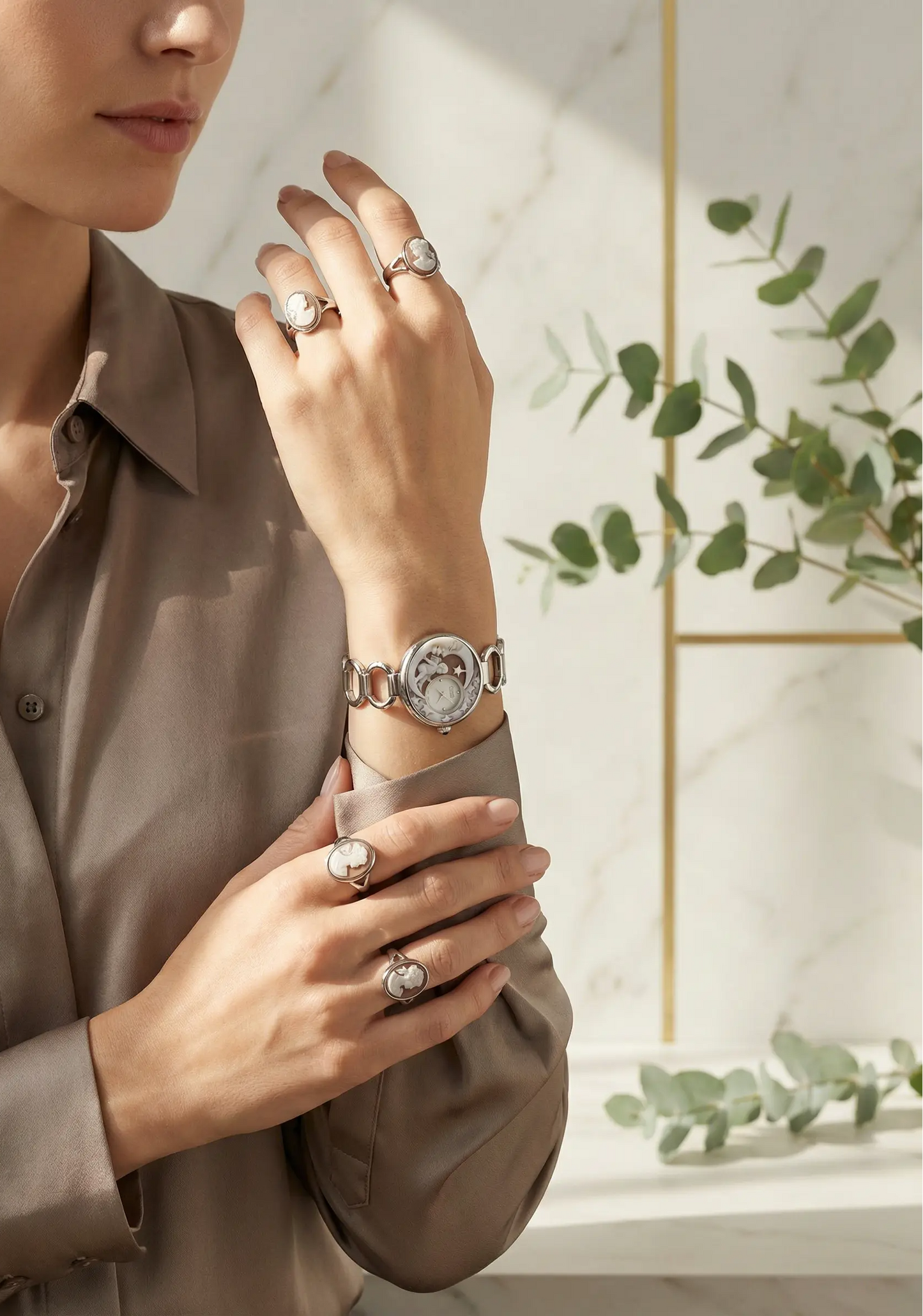 Woman wearing a watch and rings with a neutral background