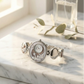 Silver watch with decorative face on a marble surface