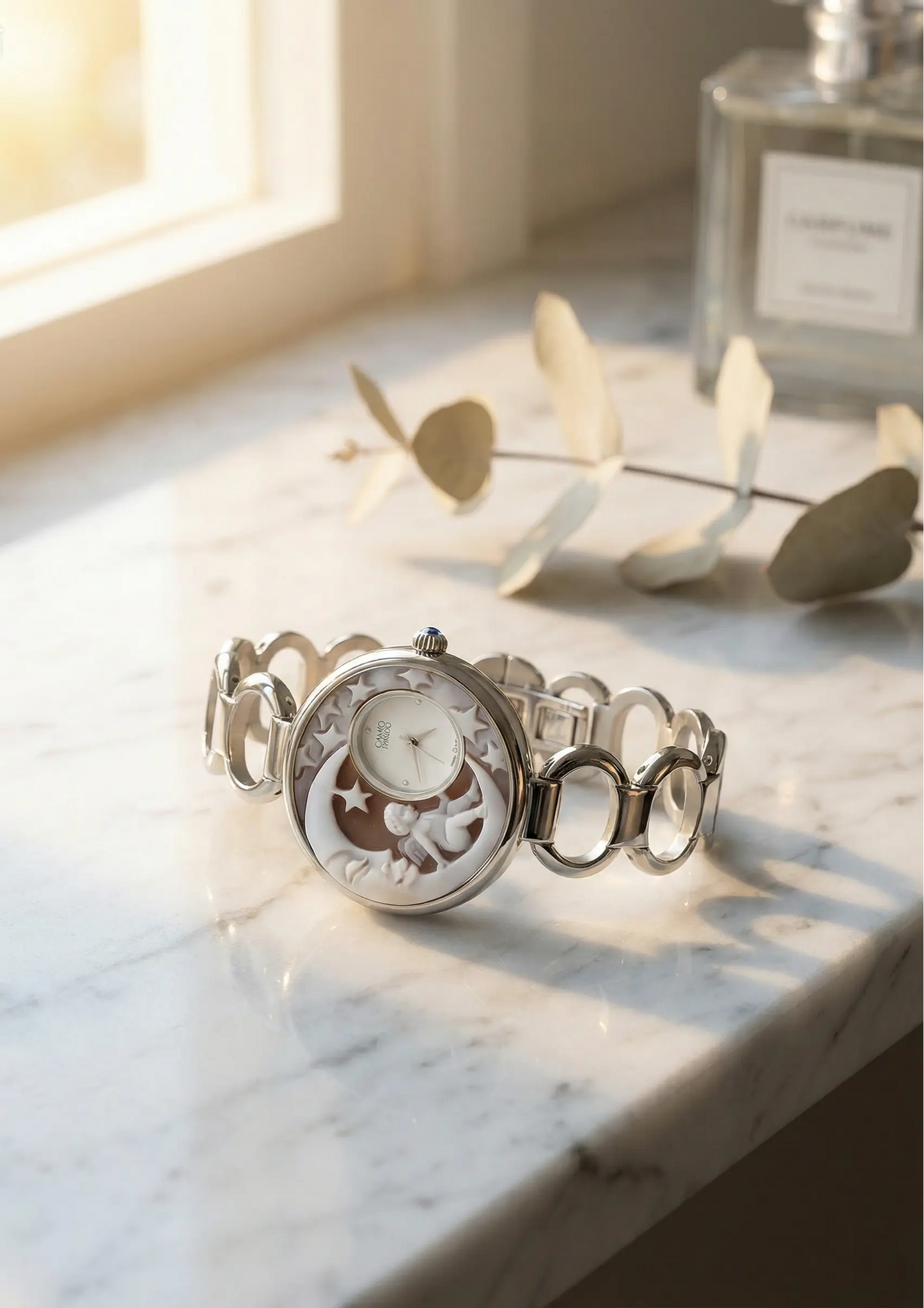 Silver bracelet with a detailed face on a marble surface