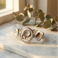 Silver bracelet watch on a marble surface with eucalyptus leaves elegant wrist watch old money
